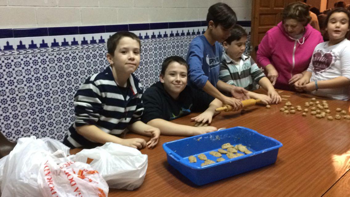 Voluntarios de María Madre de Dios haciendo borrachuelos para Cáritas parroquial